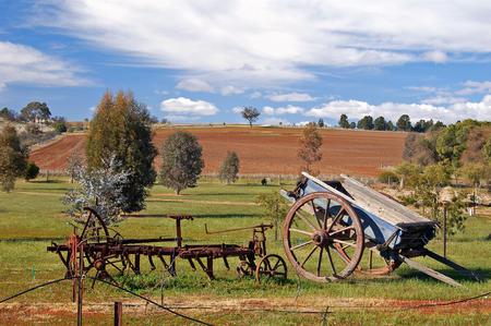 Rustic Landscape - fields, rusty objects, trees, timber wagon