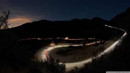 car lights on a mountain road - lights, evening, road, mountains, silhouettes