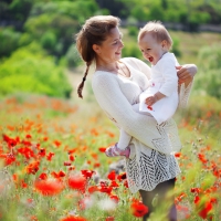 Cute child girl in poppy field