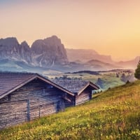 wooden cabins on an alpine meadow in morning hdr