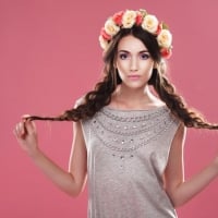 Girl on a pink background with wreath