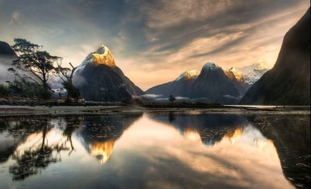 Snowy Peaks Reflections At Sunrise - sky, trees, new zealand, national park, mountains, morning calm, unesco world heritage site, clouds, dawn, snow, beautiful, milford sound, fjord, sunrise