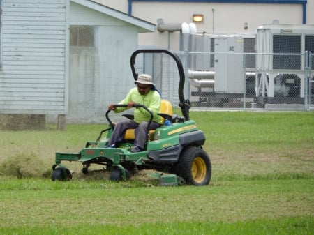 Man cutting the grass on a ride - lawn, ride, cutting, man, mower, grass