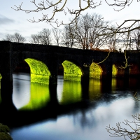 an old arch bridge at dusk