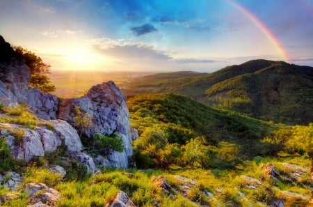 Morning rainbow - hills, summer, amazing, grass, sunrise, mountain, rainbow, view, sky, sunlight, beautiful, slope, colors, lovely, glow, nature, rays, bright, rocks, shine