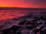 red sunset on a rocky shore