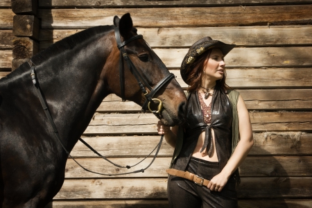 Cowgirl and Her Horse - horse, hat, wall, cowgirl, brunette