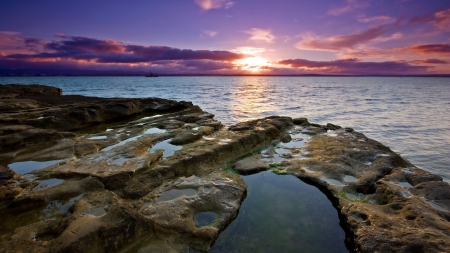 lovely peaceful sunset over rocky seashore - rocks, clouds, boat, pools, sunset, sea, shore