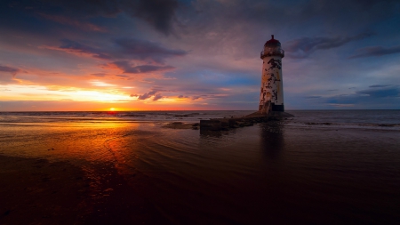 run down lighthouse at a gorgeous sunset - sunset, run down, lighthouse, beach, sea, dark