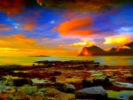 colorful sky over rocky seashore