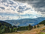 sun rays over a valley road hdr