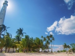 tall lighthouse on a tropical beach hdr