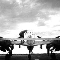 pilot climbing into a vintage p38 lightning