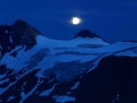 Moon over Snow-covered Mountains