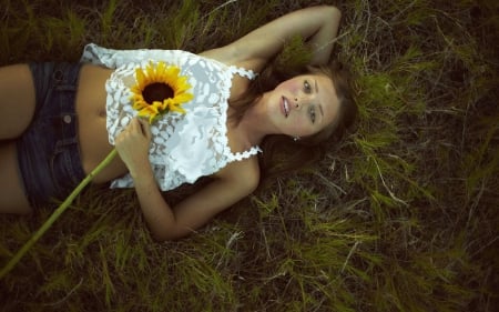 Cowgirl Lying In A Field - girls, famous, women, style, fun, models, female, fashion, cowgirls, outdoors, ranch, flowers, grass