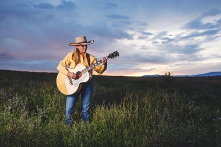 Cowgirl~Trinity Seely - style, girls, women, guitar, models, hats, cowgirls, cowgirl, hat, fun, field, singer, sunset, blondes, fashion, trinity seely, western, mountains, ranch, sky, clouds, female, music