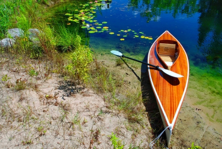 Lonely canoe on lakeshore - pretty, lonely, lilies, summer, beautiful, reflection, lakeshore, nature, lake, canoe