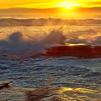 Splashing Waves on Beach at Sunset