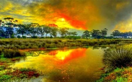 VILLAGE SUNSET - sky, landscape, colorful, water, sunset, fire, nature, forces of nature, clouds, wild, seasons, splendor, pond