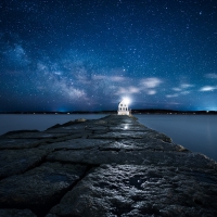 Lighthouse under Starry Sky