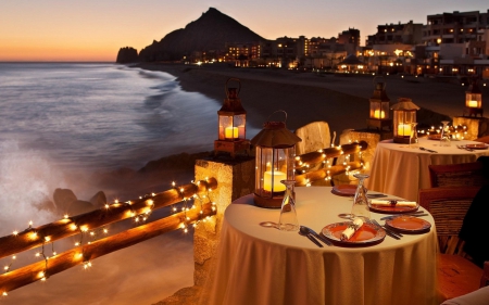 dinner at beach - summer, coast, beach, tables, evening, island, dinner, isle, shore, SkyPhoenixX1, holiday, paradise, lamps, vacation, lanterns, sea, chain of lights, ocean, nature, lights, eating, waves