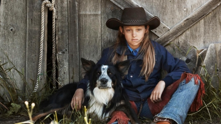 Cowgirl and Her Pal - black, chaps, beautiful, blonde, girl, white, cowgirl, dogs, hat, jeans, boots, child, animals, rope, wood, kid, outside, dog