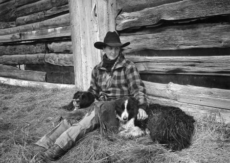 Real Cowgirl - hat, cowgirl, dogs, chaps, wood, straw, building