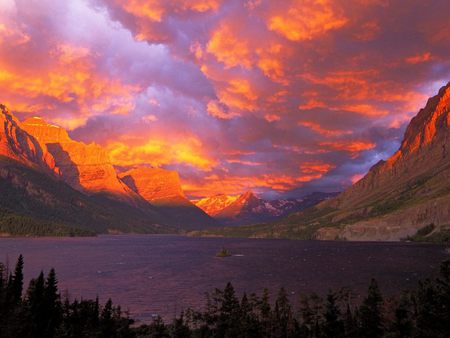 Sunrise over St Marys Lake, Montana - lakes, forest, montana, fresh water, beautiful, pine trees, folige, nature, mountians, sunset, autumn, mountains, purple, sun, glacier, season, lake, sky, clouds, orange, trees, sunrise, sonrise