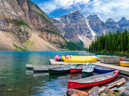 Moraine lake canoes - alberta, peaceful, rocks, reflection, calmness, cliffs, canoes, moraine, lake, landscape, mountain, summer, shore, peaks, lovely, serenity, beautiful, canada