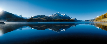 Morning Alpine Lake Panorama - lake, panorama, snowy peaks, mountains, morning mist, forest, reflection, blue, beautiful, sunrise, switzerland