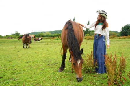 Cowgirl and Her Horses - horses, horse, cowgirl, hat, field, trees, mountain, grass