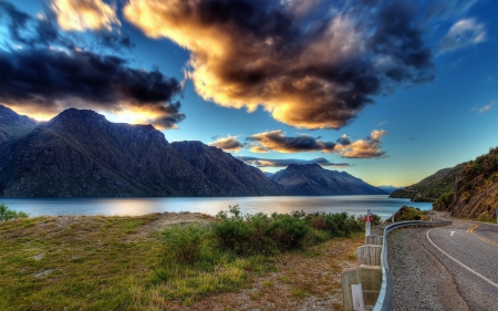 new zealand landscape - road, clouds, river, mountain, grass