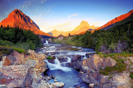 Swiftcurrent Falls At Sunrise - forest, beautiful, waterfalls, blue sky, mountains, sunrise, cottages