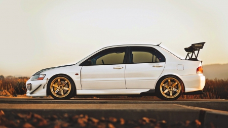 Mitsubishi-Lancer-Evolution-Evo - white, 4 door, gold rims, spolier