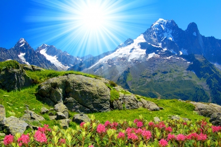 Mountain lit by the sun - sky, sunshine, valley, freshness, dazzling, slope, sun, shine, rocks, view, grass, cliffs, rays, sunlight, mountain, peaks, bright, glow, beautiful, stones, wildflowers