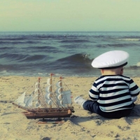 Child playing in the sand, the sea