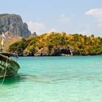 Green boat on the clear ocean