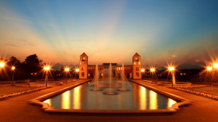 Fountains and Lights - fountain, evening, light, photo, fountains, SkyPhoenixX1, street lamps, lamps, abstract, trees, water, pond, photography, lanterns, orange, pool, lights, building