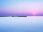 lighthouse on pier at dawn