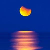 orange moon in blue sky