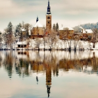 church on an isle in lake bled slovenia in winter