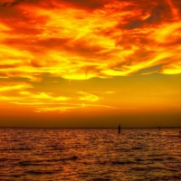 fishing boat returning at golden sunset hdr