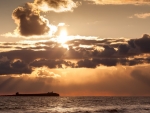 sunset over an island offshore