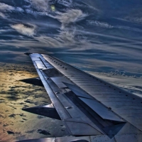 plane wing tip above the clouds hdr