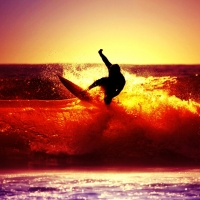 surfing on red waves at sunset