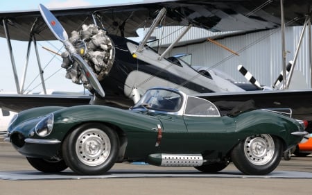 1957 Jaguar XK beside a Biplane