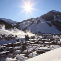 sunshine over a ski resort town in austria