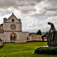 staue of francis of assisi in front of a church