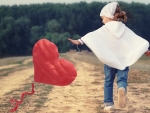 Little girl and heart kite