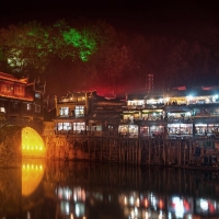 bridge on a river in feng huang at night